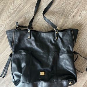 Womens black purse with gold zipper details